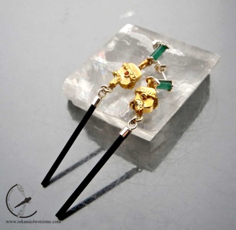 Silver earrings with emeralds, black tourmalines, sapphires and a snake motif.